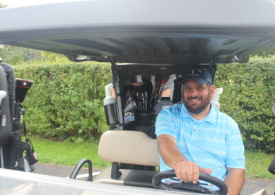 A man sitting in a golf cart.