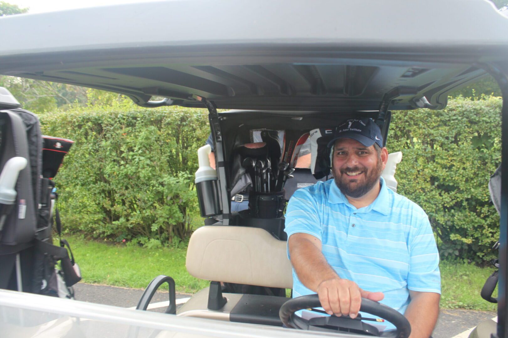 A man sitting in a golf cart.