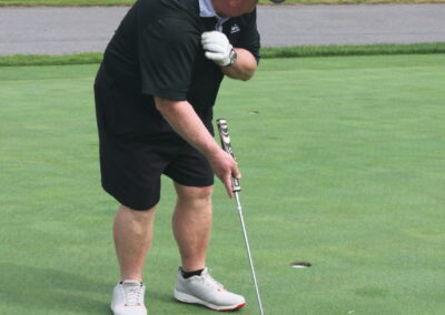 A man is putting a golf ball on a green.