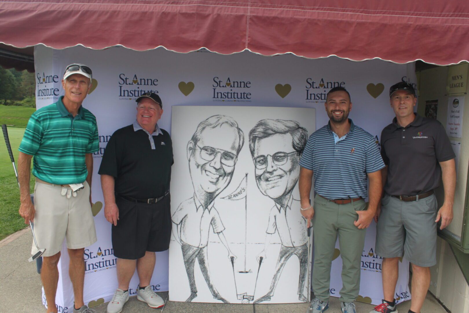 A group of men posing for a photo with a caricature.