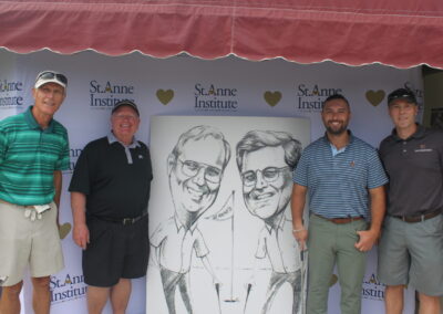 A group of men posing for a photo in front of a caricature.