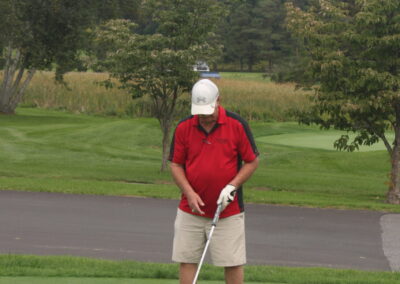 A man is preparing to hit a golf ball.