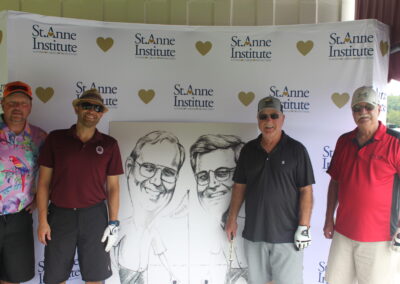 A group of men posing in front of a caricature.