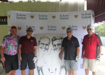 A group of men standing in front of a caricature.