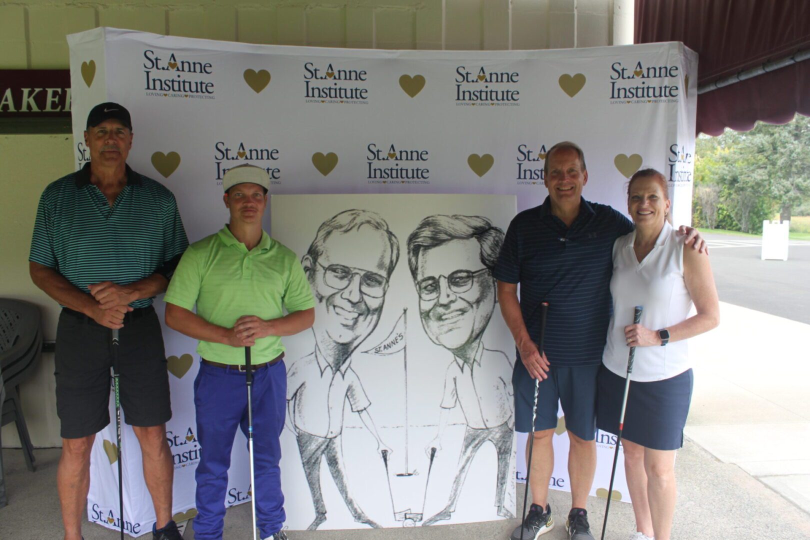 A group of people posing for a photo with a caricature.