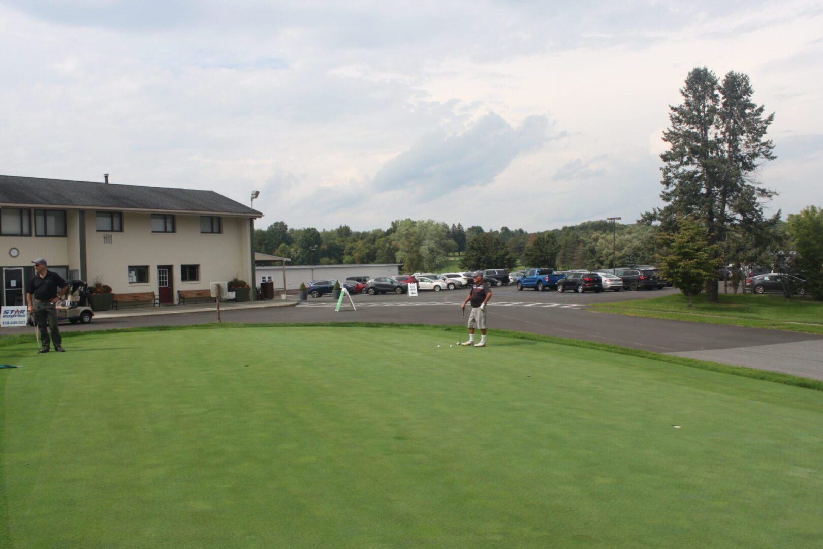 A man is playing golf on a green.