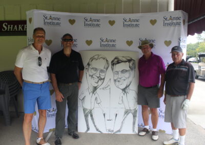 A group of men posing for a photo with a caricature.