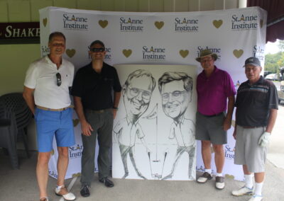 A group of men posing for a photo with a caricature.