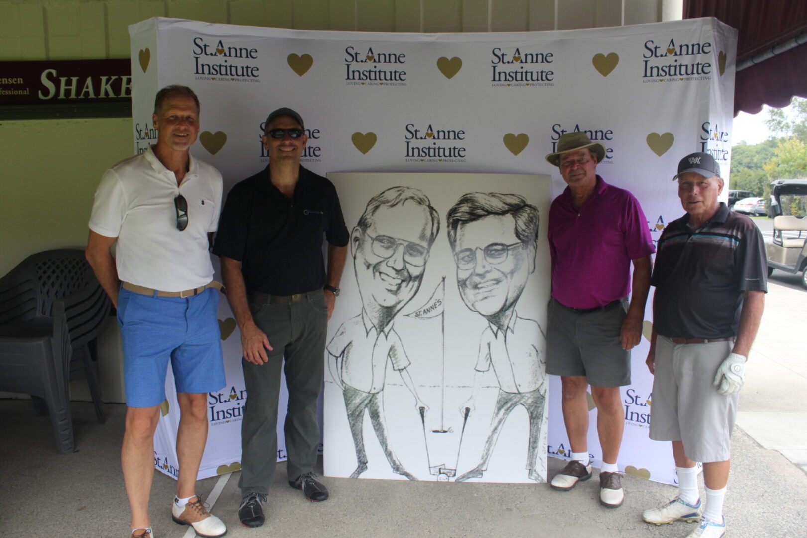 A group of men posing for a photo with a caricature.