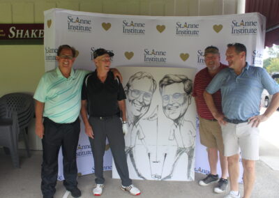 A group of men posing for a photo with a caricature.