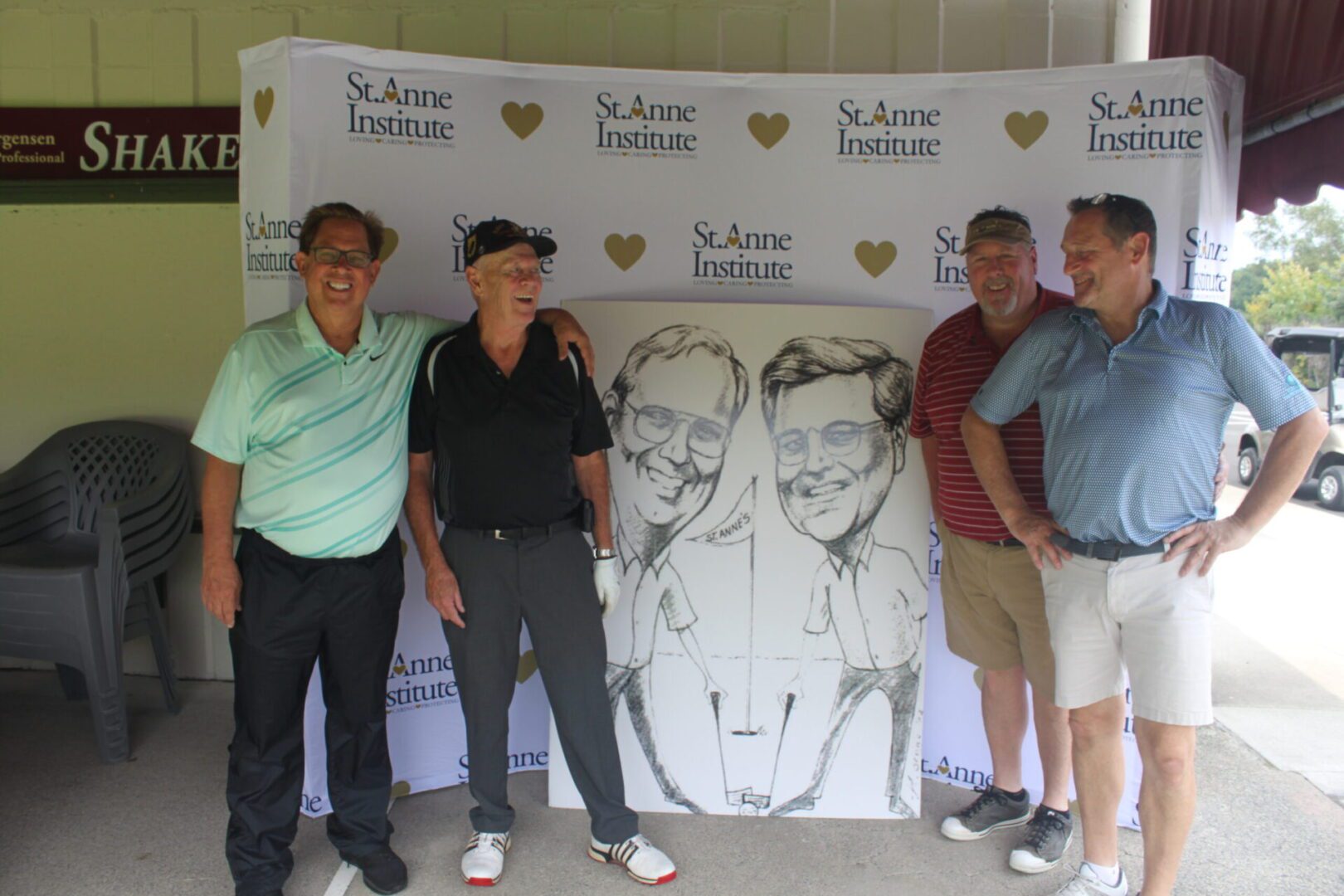A group of men posing for a photo with a caricature.