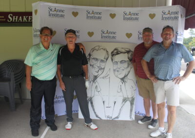 A group of men posing for a photo with a caricature.