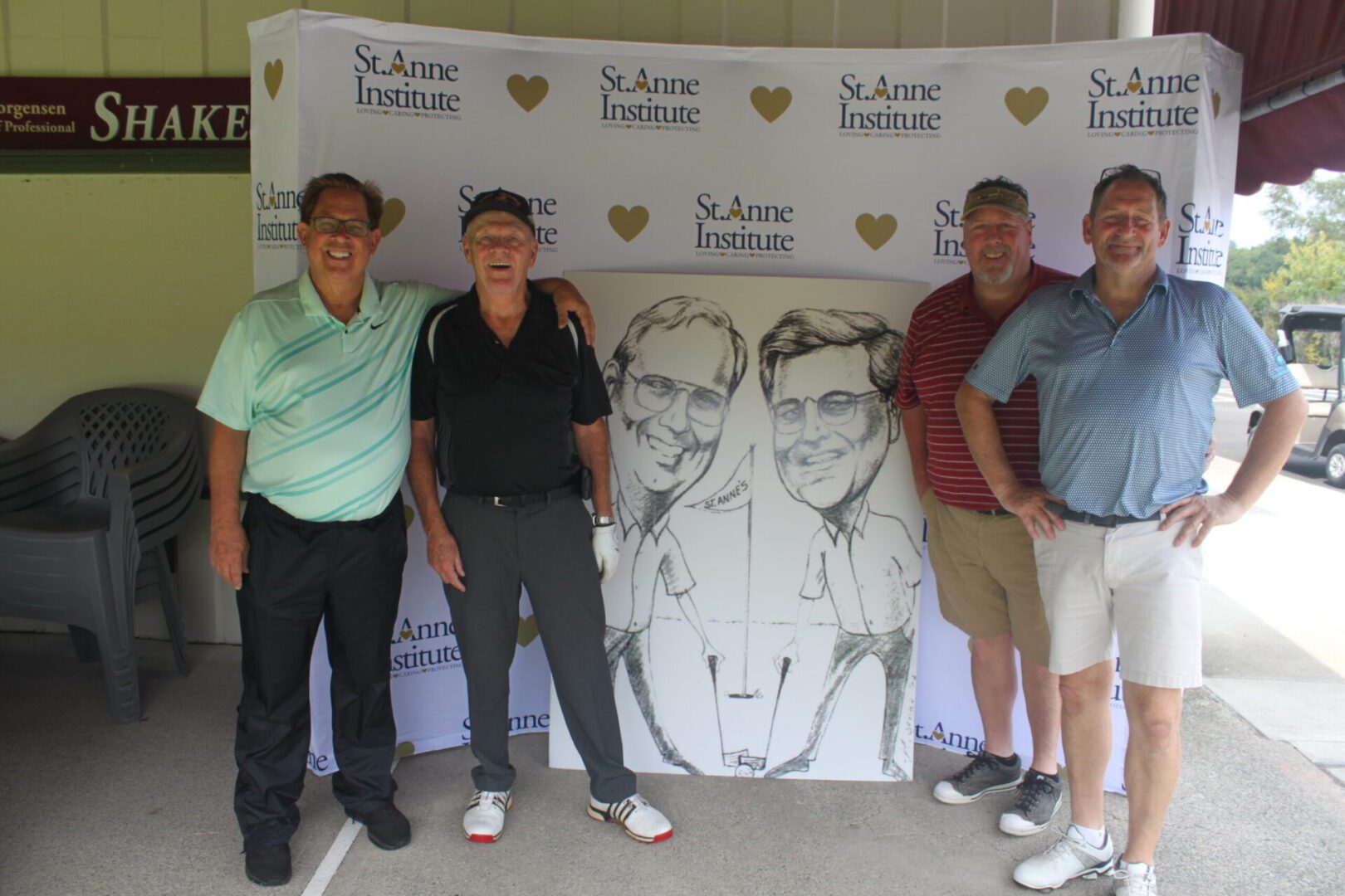 A group of men posing for a photo with a caricature.