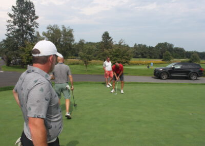 A group of people on a golf course.