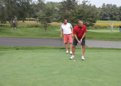 A group of people on a golf course.