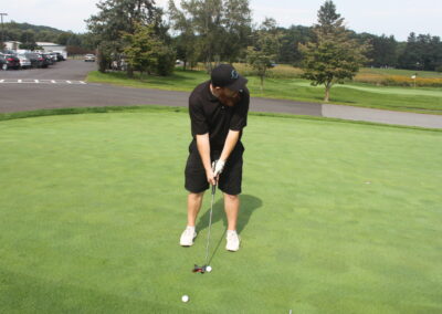 A man is putting a golf ball on a green.