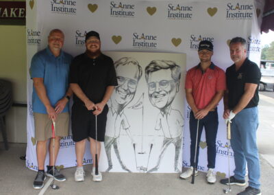 A group of men posing for a photo with a caricature.