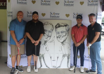 A group of men posing for a photo with a caricature.