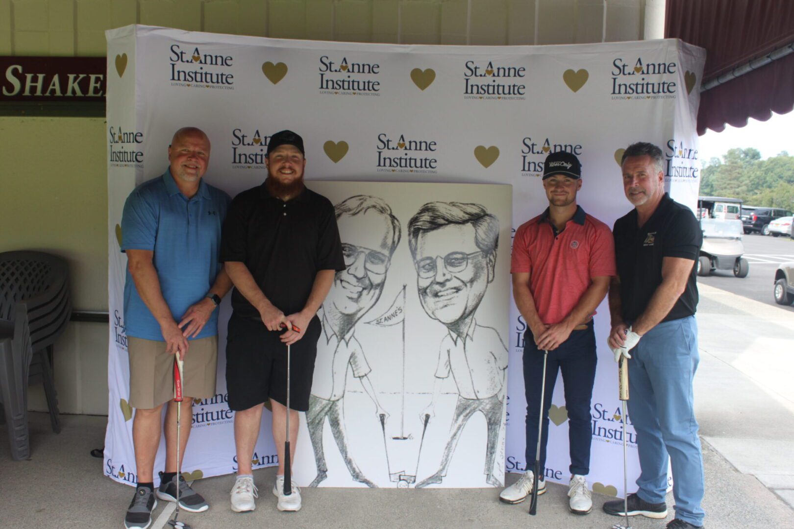 A group of men posing for a photo with a caricature.