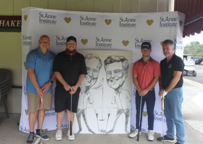 A group of men posing for a photo with a caricature.