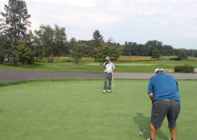 A group of people on a golf course.