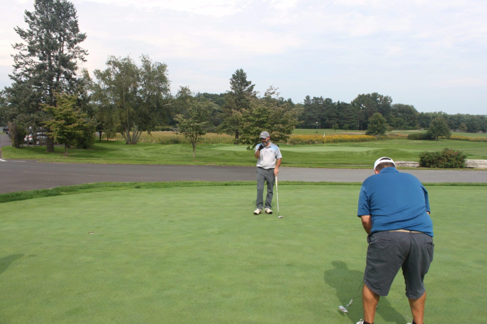 A group of people on a golf course.