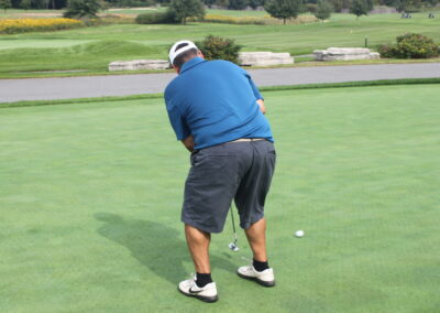 A man is putting a golf ball on a green.