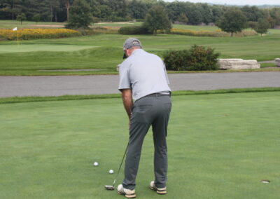 A man is putting on a golf course.