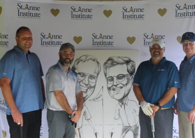 A group of men posing for a photo with a caricature.