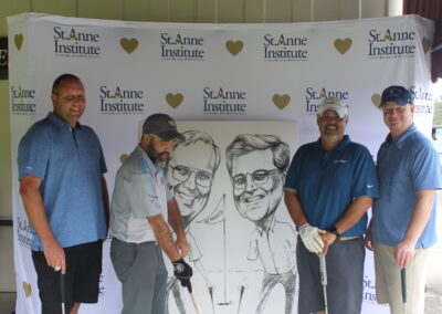 A group of men posing for a photo with a caricature.