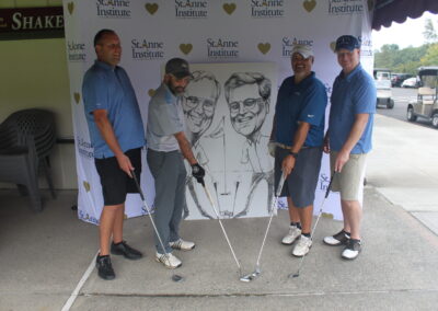 A group of men posing with golf clubs.