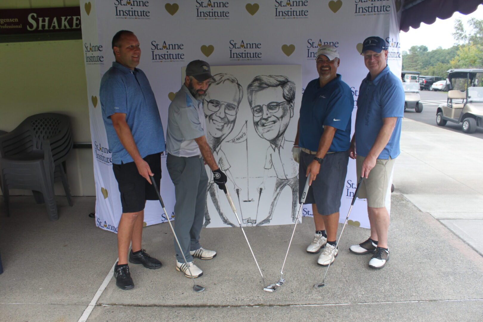 A group of men posing with golf clubs.