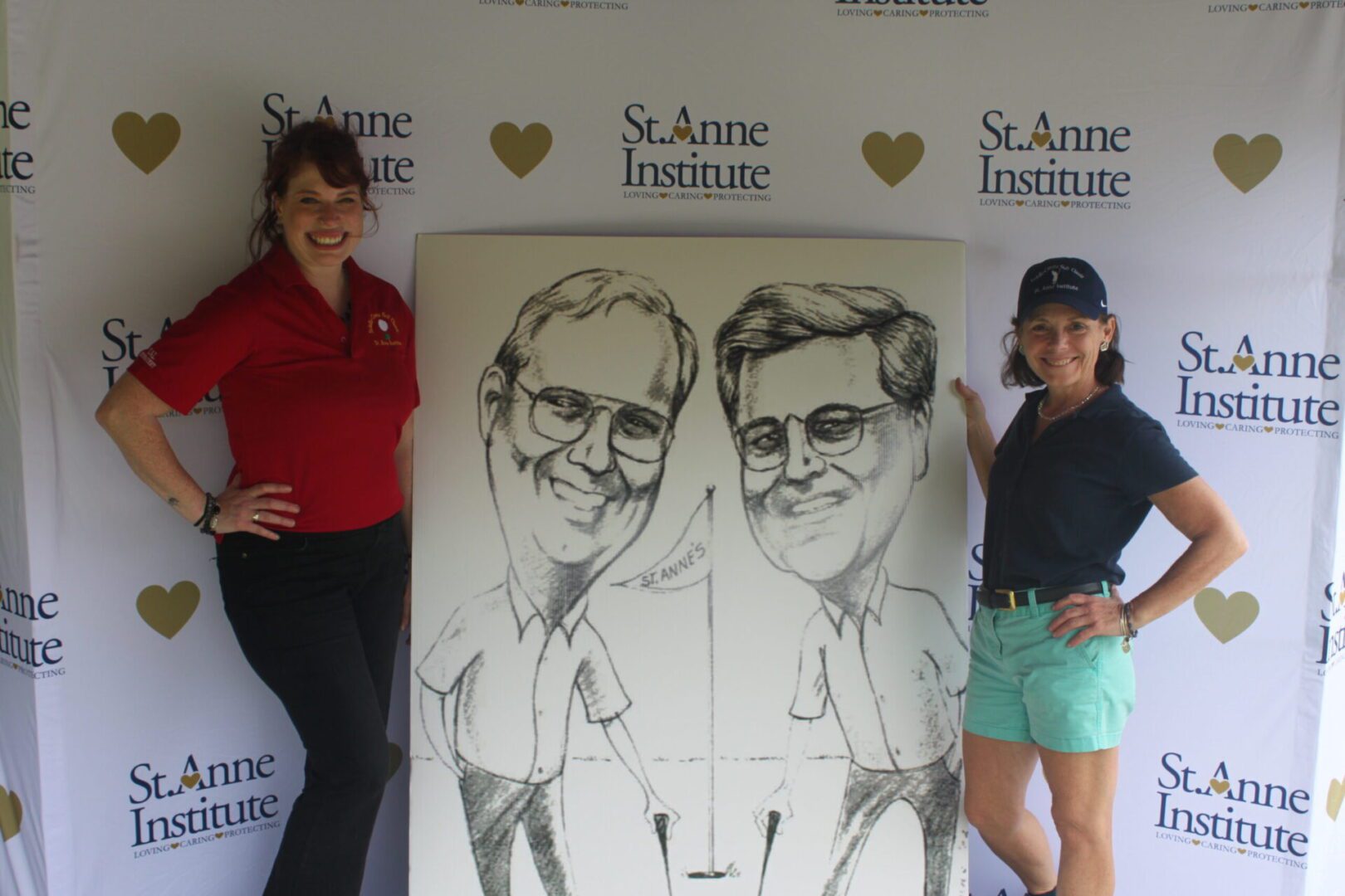 Two women standing next to a caricature.
