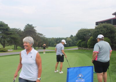 A group of people on a golf course.