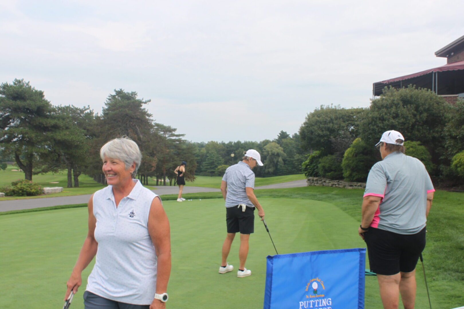 A group of people on a golf course.