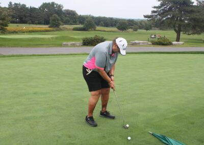 A man is putting a golf ball on a green.