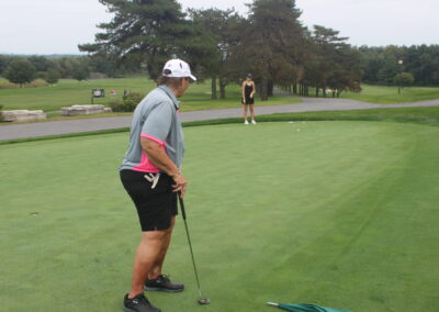 A man is putting a golf ball on a green.