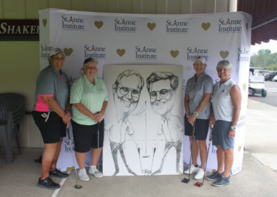 A group of people posing for a photo with a caricature.