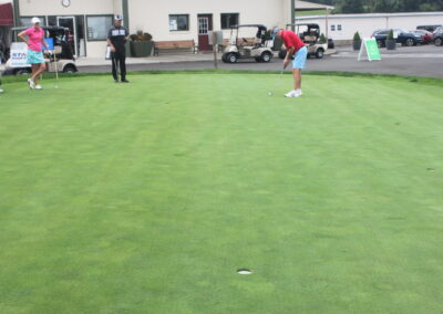 A group of people playing a game of golf.