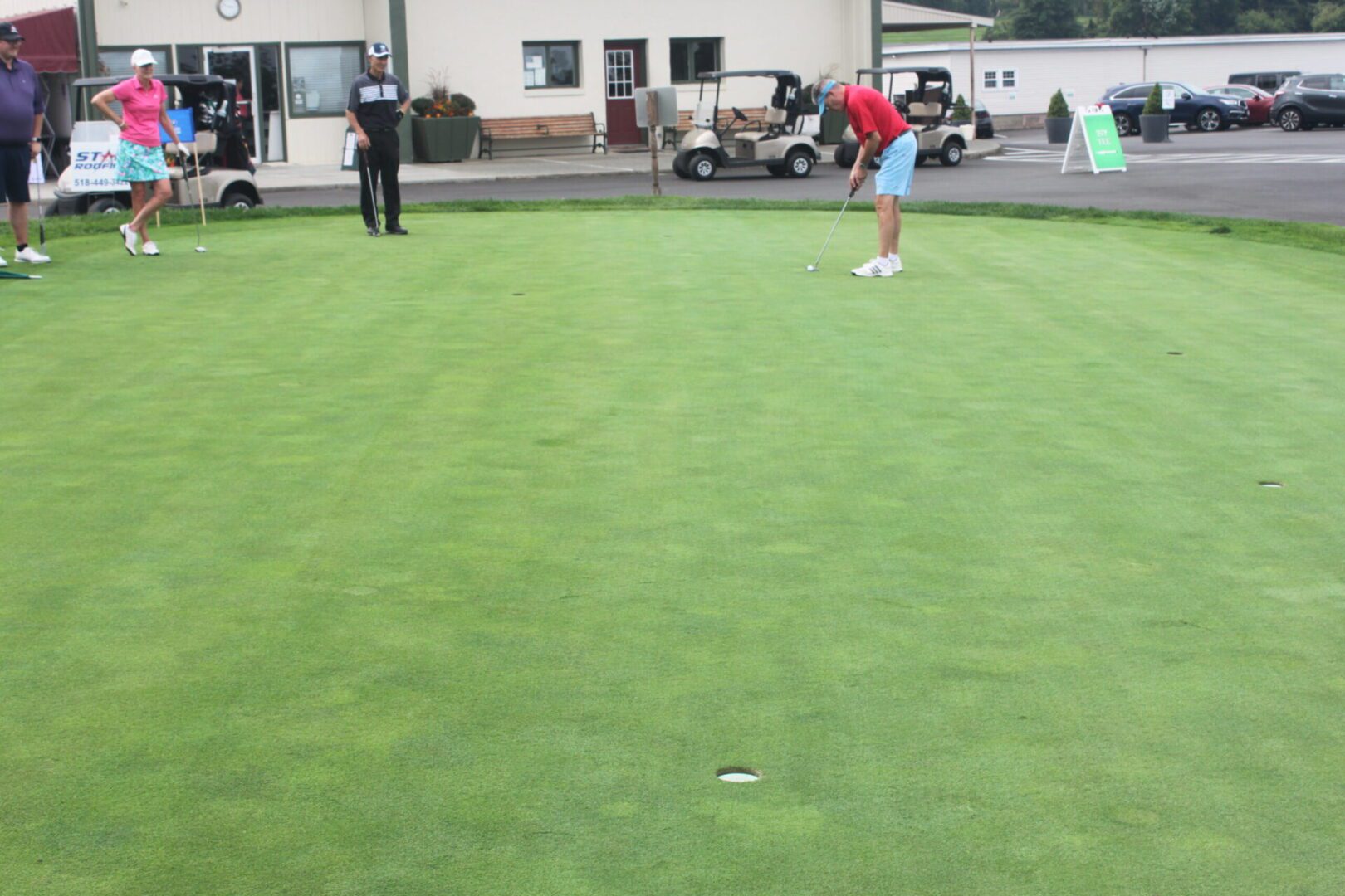 A group of people playing a game of golf.