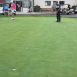 A group of people playing a game of golf.