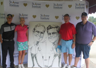 A group of people posing in front of a caricature.