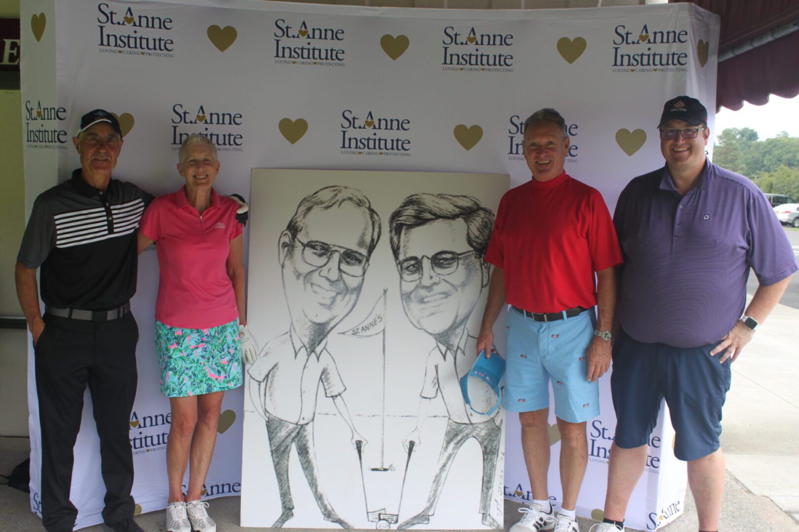 A group of people posing in front of a caricature.
