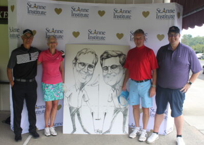 A group of people posing for a photo with a caricature.