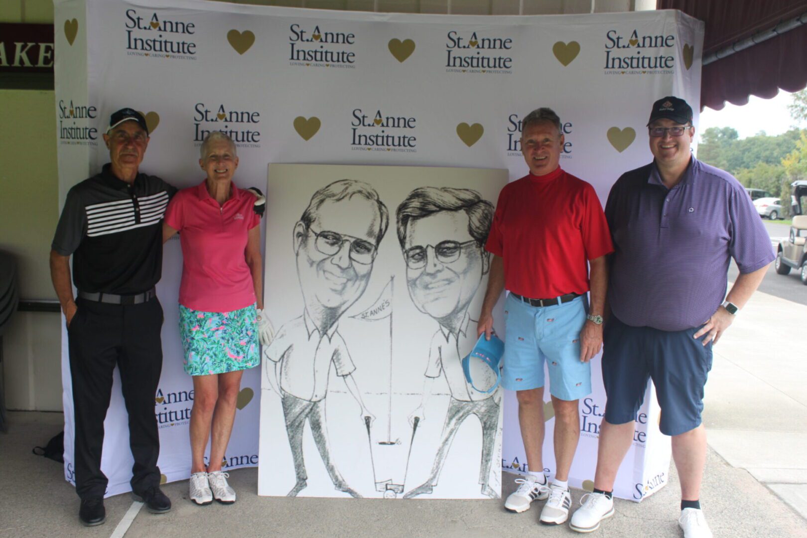 A group of people posing for a photo with a caricature.