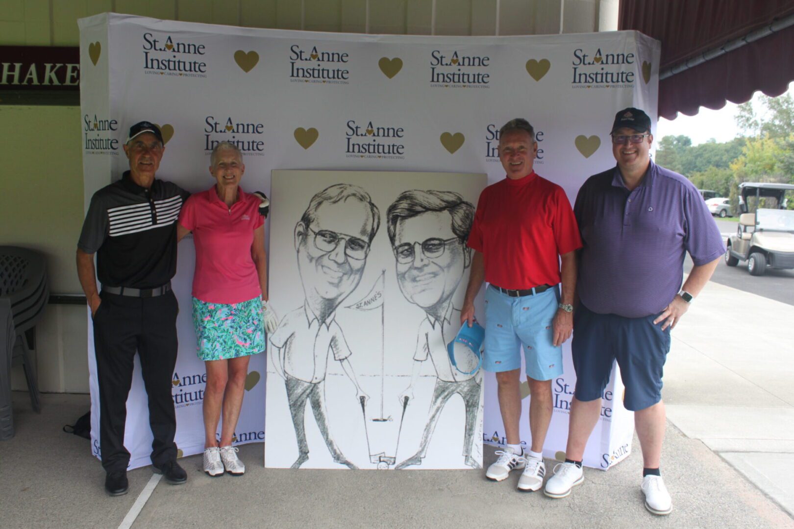 A group of people posing in front of a caricature.