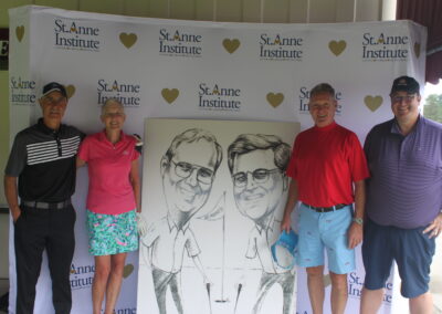 A group of people posing for a photo with a caricature.