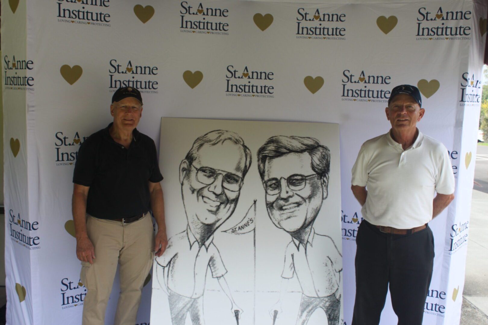 Two men standing next to a caricature.