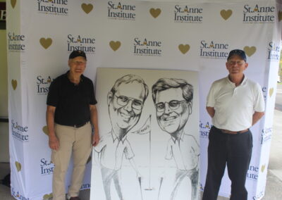 Two men standing next to a caricature of two men.