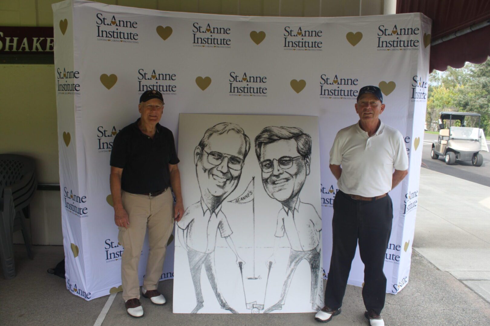 Two men standing next to a caricature.